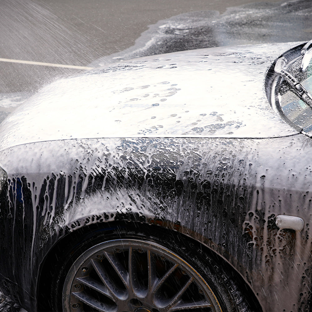black car covered in car wash solution